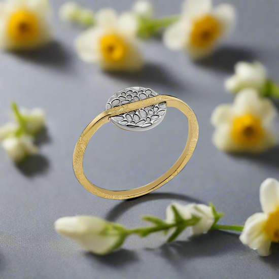 Photo of “Kymbal” Ring in a decorative scene, designed by , available at Plumb Gold & Plumb Silver