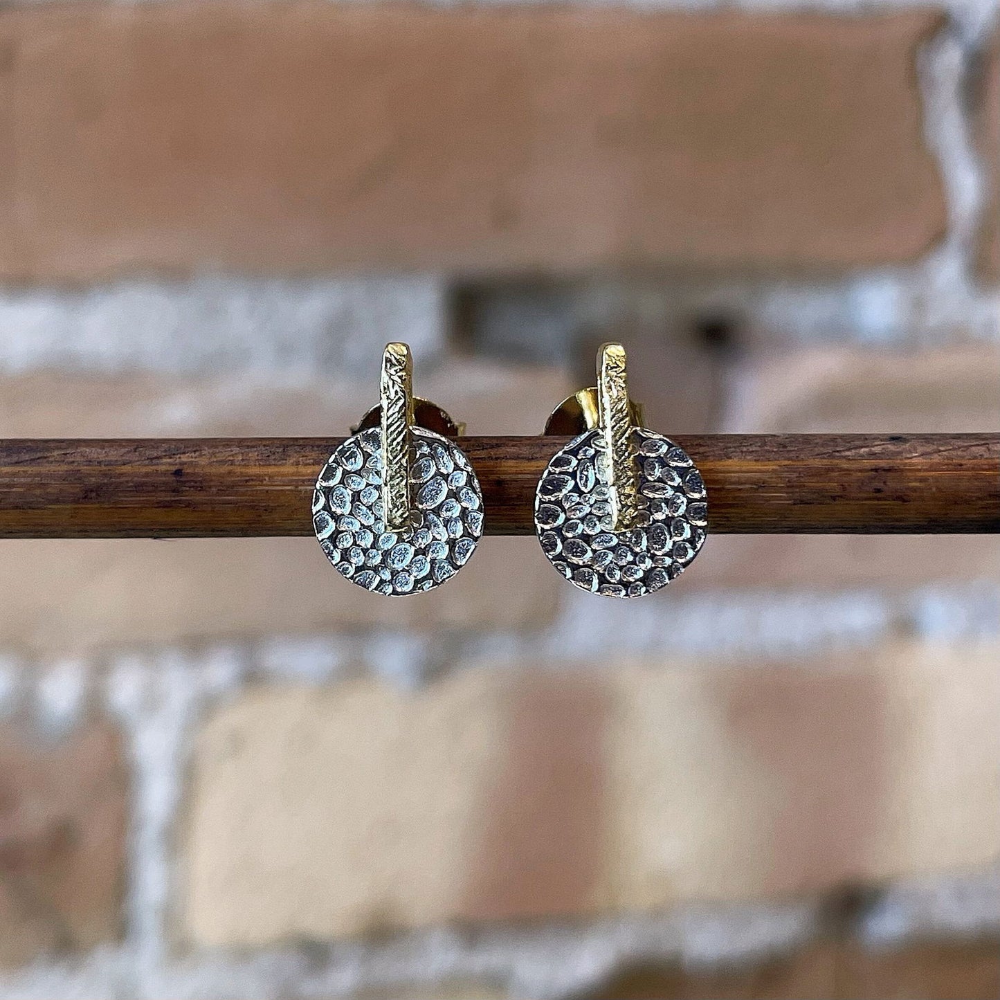 Photo of “Kymbal” Studs in a decorative scene, designed by , available at Plumb Gold & Plumb Silver