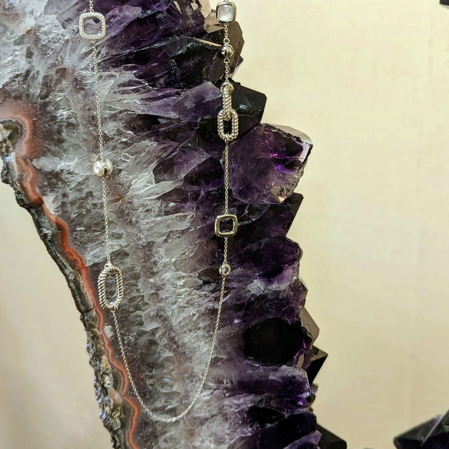 Photo of Long Station Necklace in a decorative scene, designed by , available at Plumb Gold & Plumb Silver