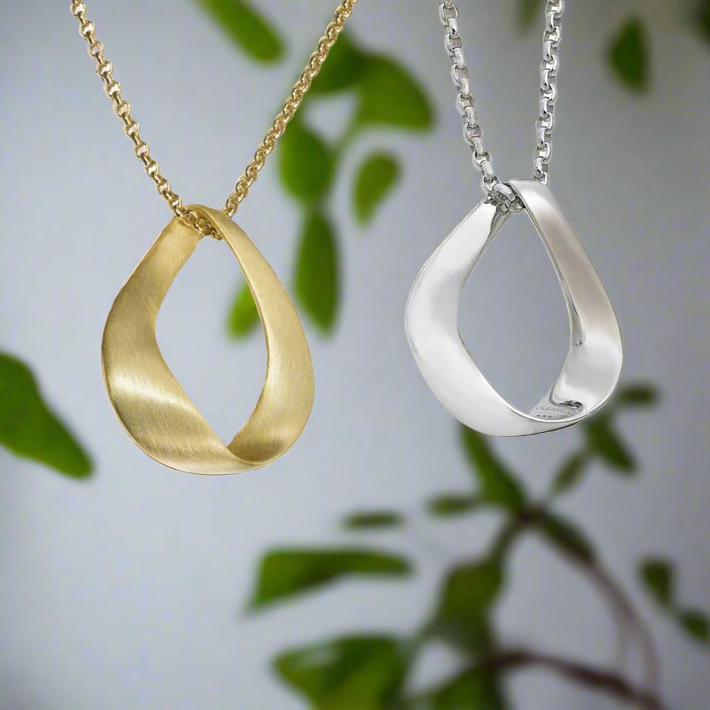 Photo of "Love" Pendant in a decorative scene, designed by -, available at Plumb Gold & Plumb Silver