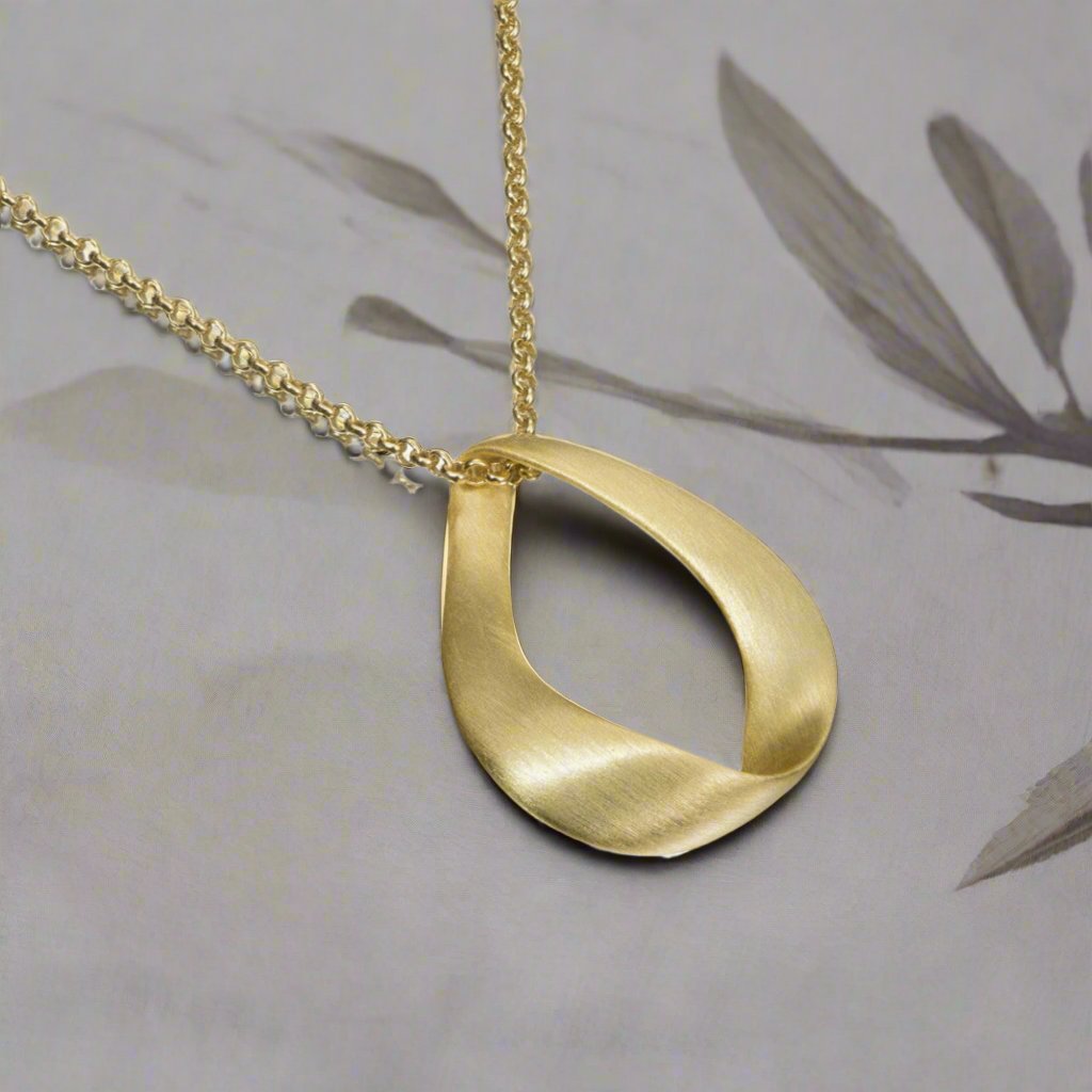 Photo of "Love" Pendant in a decorative scene, designed by -, available at Plumb Gold & Plumb Silver