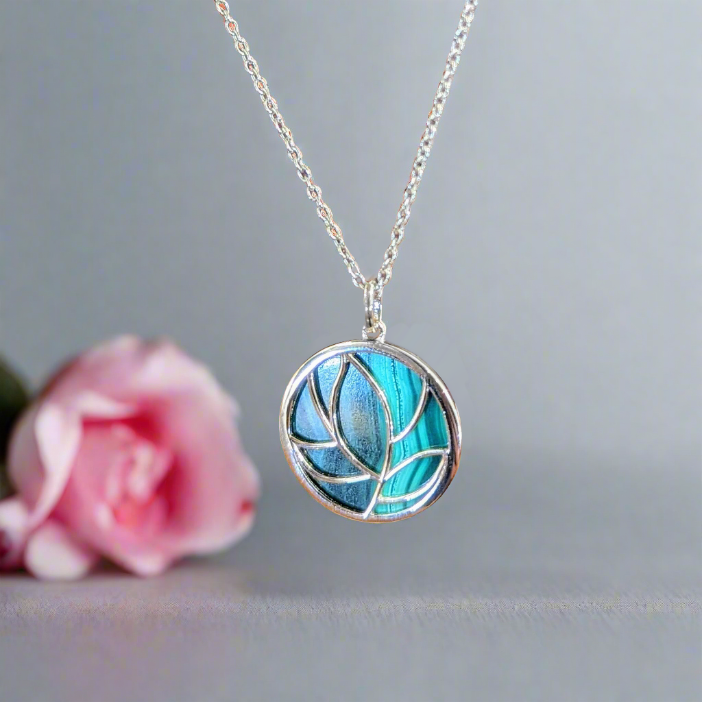 Photo of Malachite Floral Pendant in a decorative scene, designed by , available at Plumb Gold & Plumb Silver