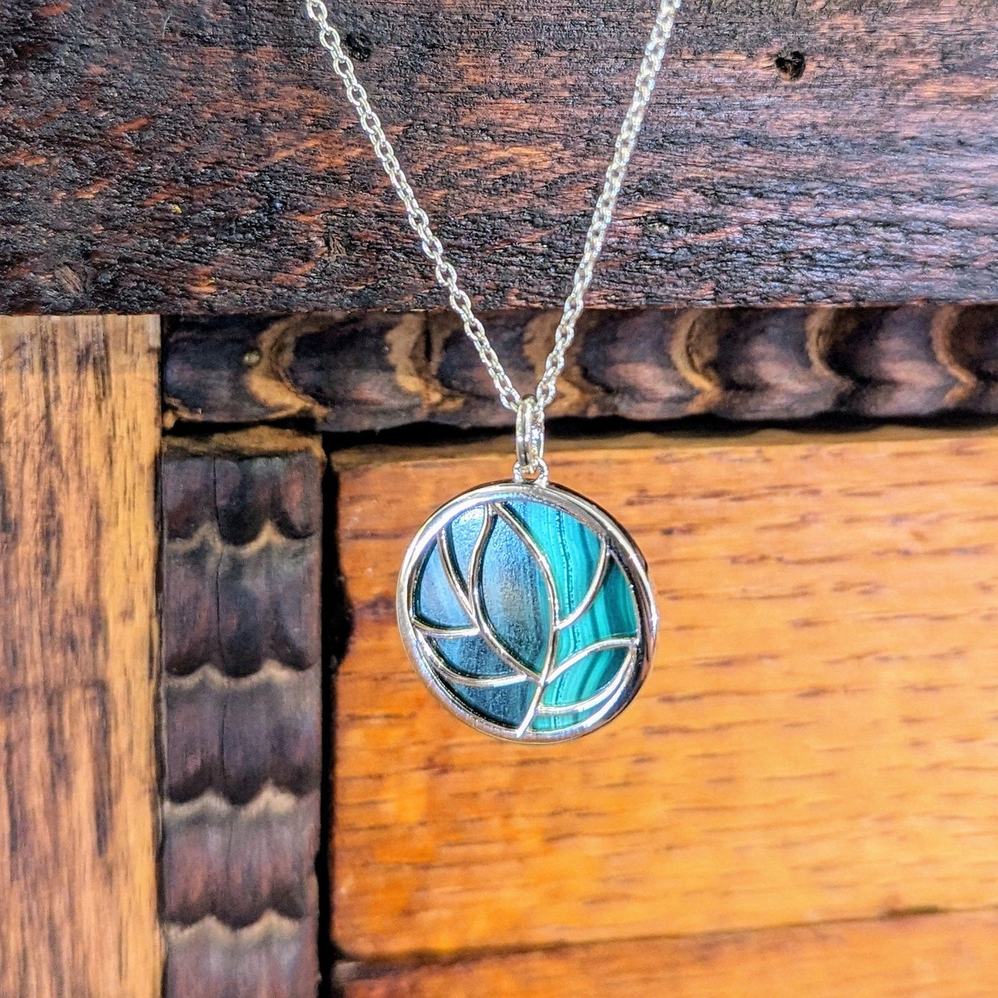 Photo of Malachite Floral Pendant in a decorative scene, designed by , available at Plumb Gold & Plumb Silver