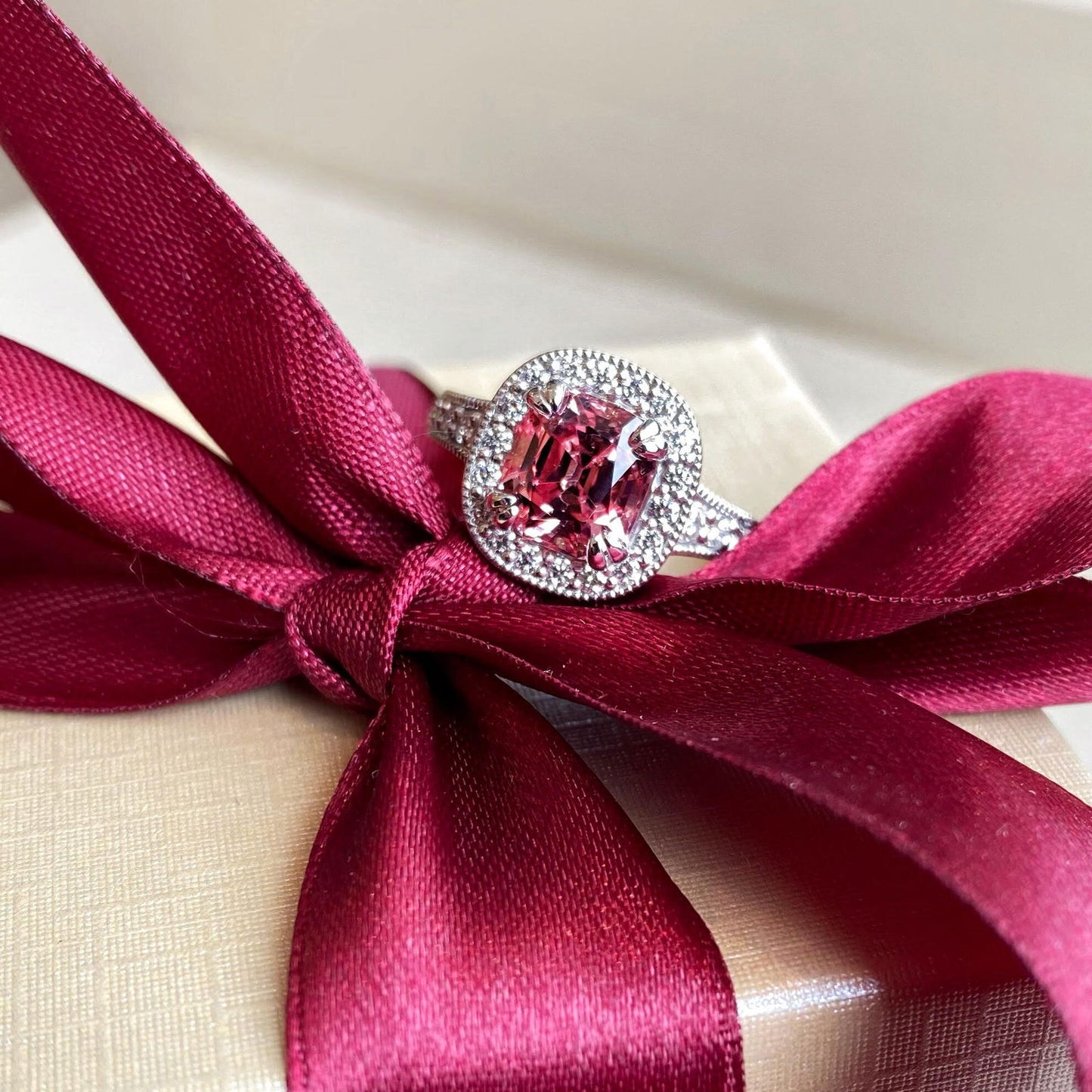Photo of Malaya Garnet Ring in a decorative scene, designed by , available at Plumb Gold & Plumb Silver