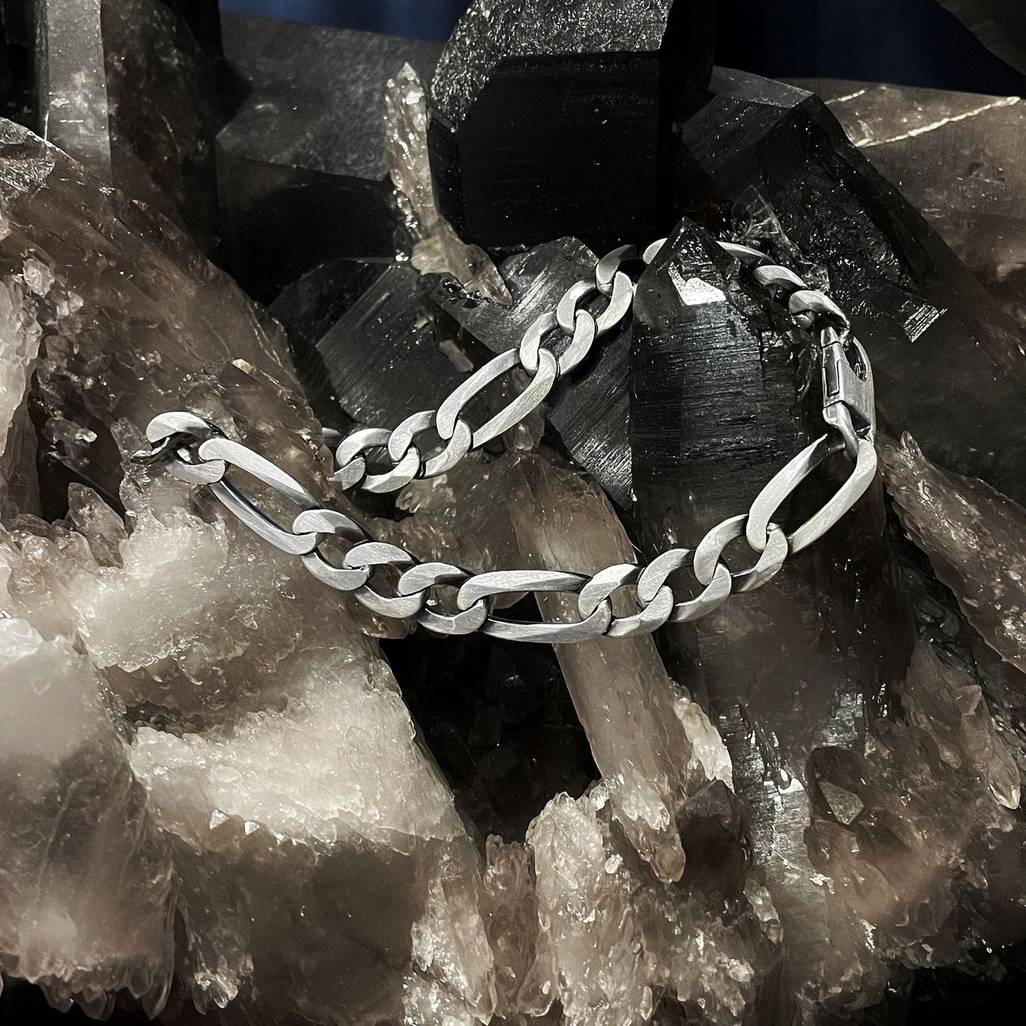 Photo of Matte Figaro Bracelet in a decorative scene, designed by , available at Plumb Gold & Plumb Silver