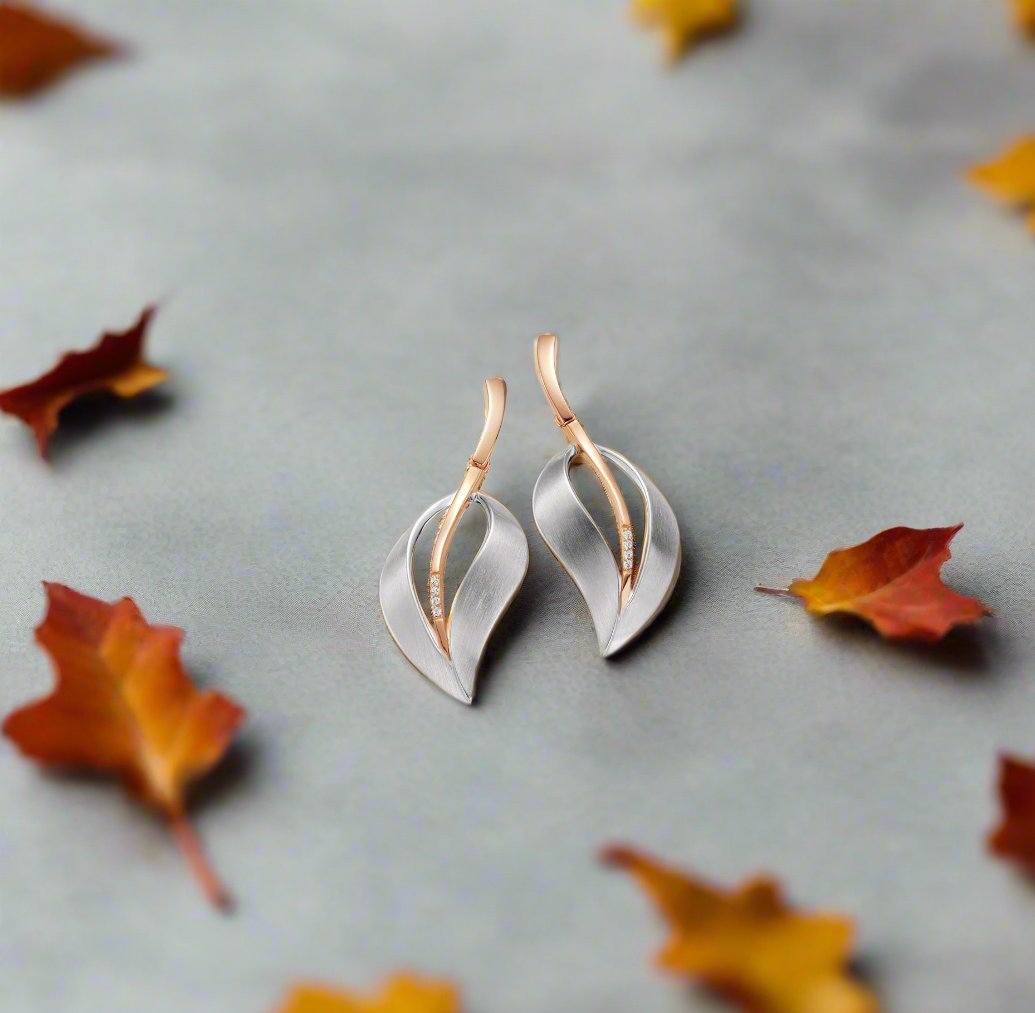 Photo of Matte Silver Leaf Earrings in a decorative scene, designed by , available at Plumb Gold & Plumb Silver