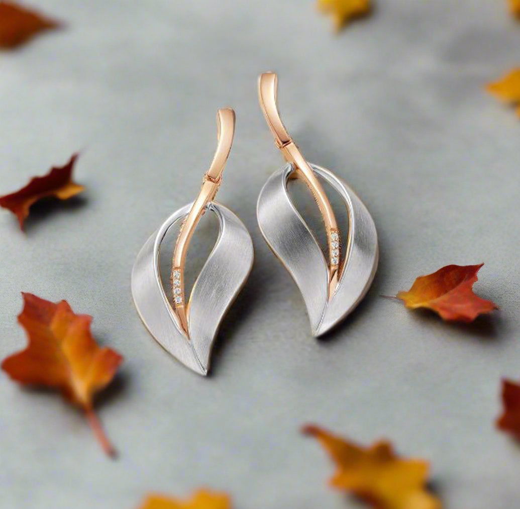 Photo of Matte Silver Leaf Earrings in a decorative scene, designed by , available at Plumb Gold & Plumb Silver