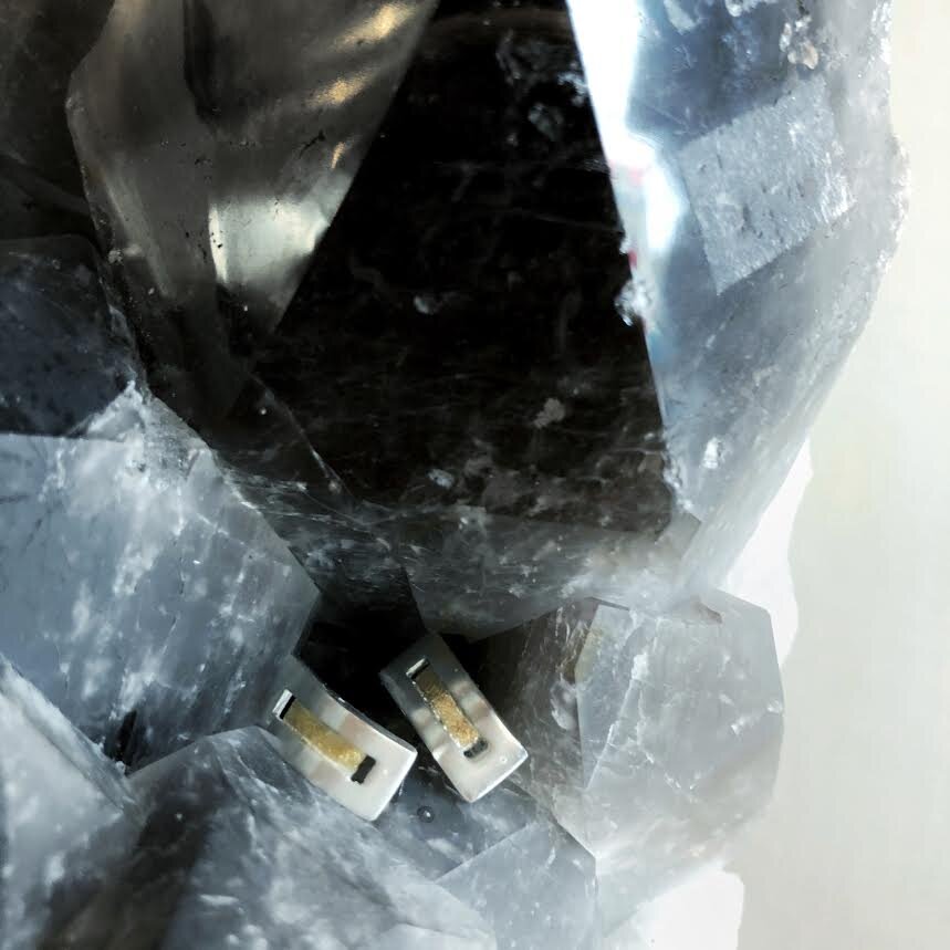 Photo of Modern Rectangle Stud Earrings in a decorative scene, designed by , available at Plumb Gold & Plumb Silver
