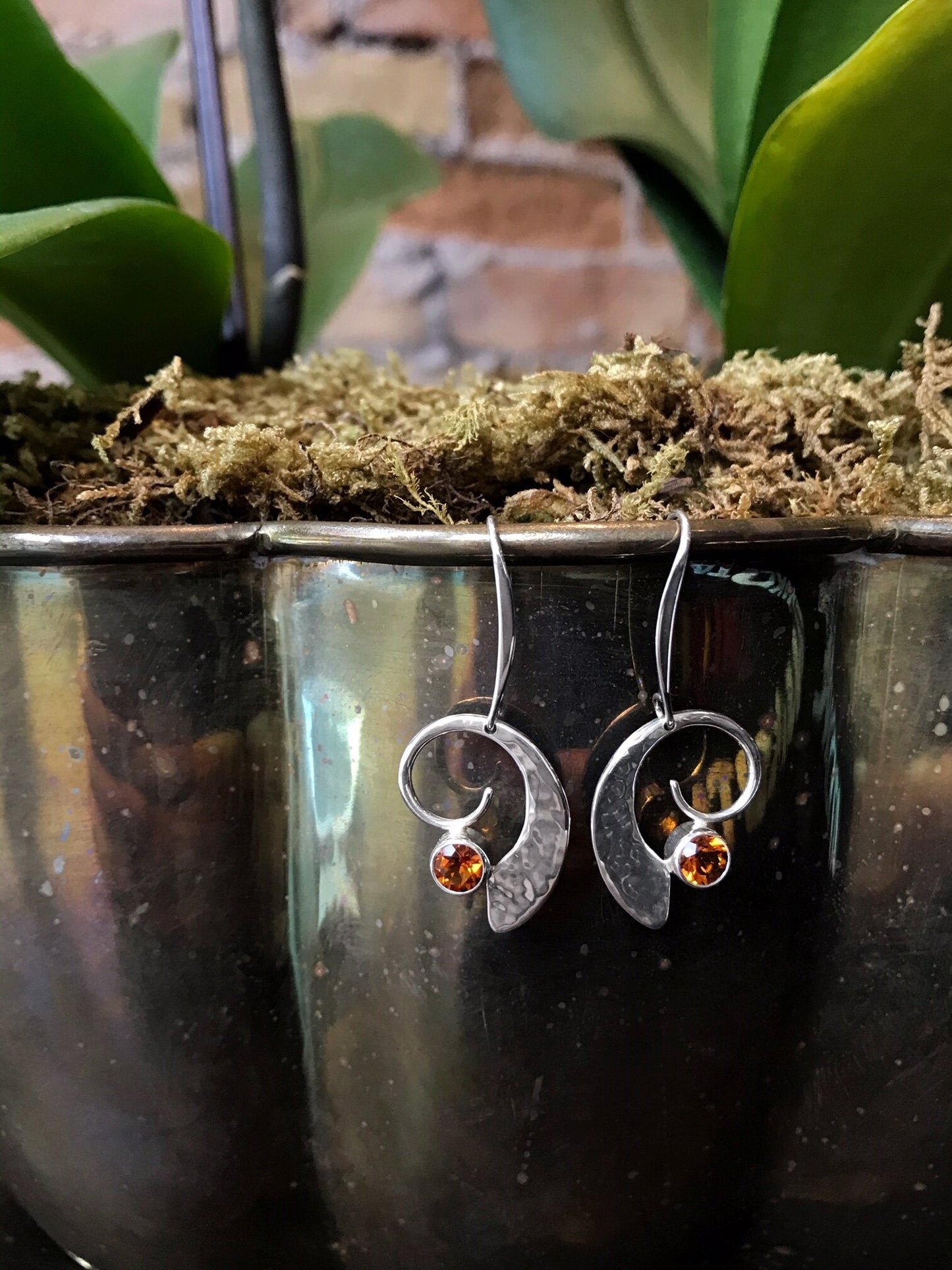 Photo of "Moon Dance" Earrings in a decorative scene, designed by , available at Plumb Gold & Plumb Silver