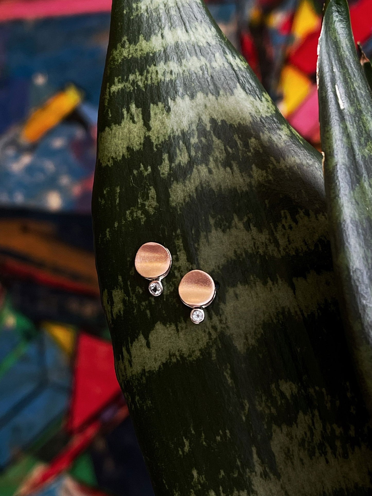 Photo of "Moon" Earrings in a decorative scene, designed by , available at Plumb Gold & Plumb Silver