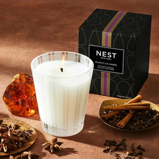 Photo of Moroccan Amber Candle in a decorative scene, designed by , available at Plumb Gold & Plumb Silver