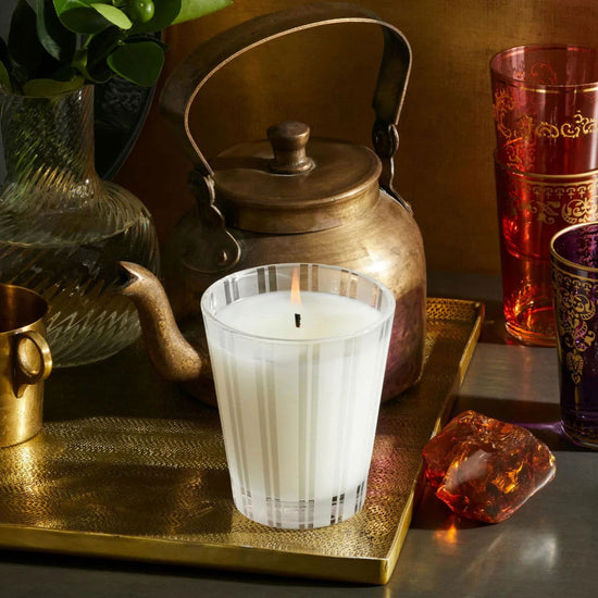 Photo of Moroccan Amber Candle in a decorative scene, designed by , available at Plumb Gold & Plumb Silver