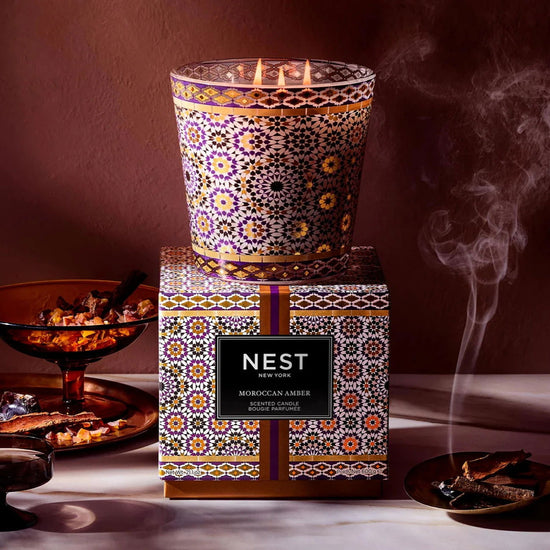 Photo of Moroccan Amber Candle in a decorative scene, designed by , available at Plumb Gold & Plumb Silver