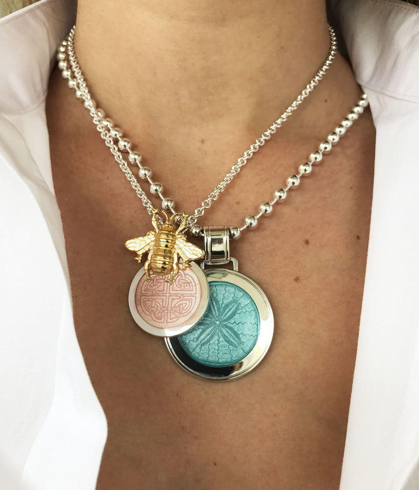 Photo of Mother and Daughter Small Celtic Knot Pendant in a decorative scene, designed by , available at Plumb Gold & Plumb Silver