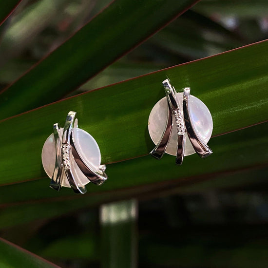 Photo of Mother of Pearl and Diamond Earrings in a decorative scene, designed by , available at Plumb Gold & Plumb Silver