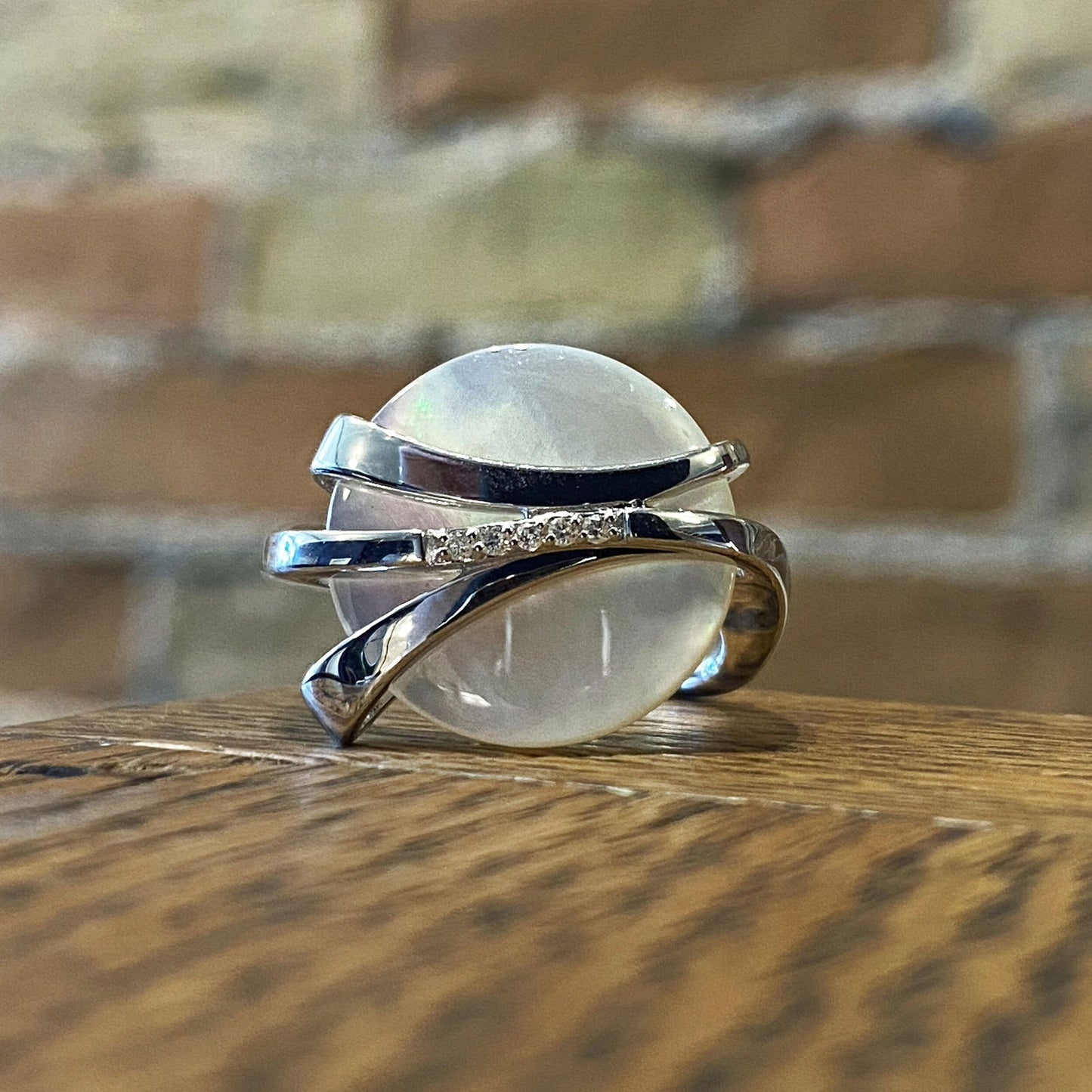 Photo of Mother of Pearl and Diamond Ring in a decorative scene, designed by , available at Plumb Gold & Plumb Silver