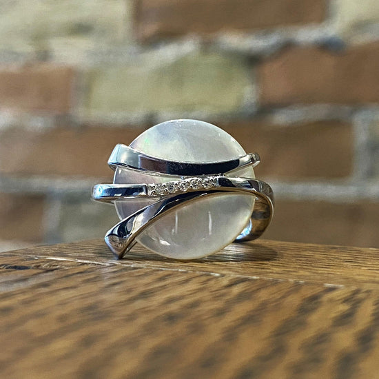 Photo of Mother of Pearl and Diamond Ring in a decorative scene, designed by , available at Plumb Gold & Plumb Silver