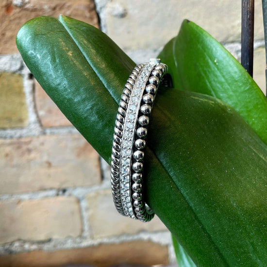 Photo of Multi-Texture Cubic Zirconia Bracelet in a decorative scene, designed by , available at Plumb Gold & Plumb Silver