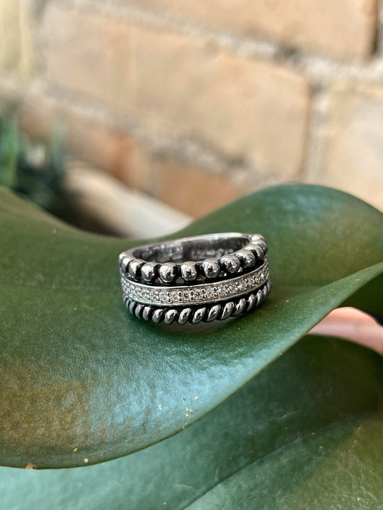 Photo of Multi-Texture Cubic Zirconia Ring in a decorative scene, designed by , available at Plumb Gold & Plumb Silver