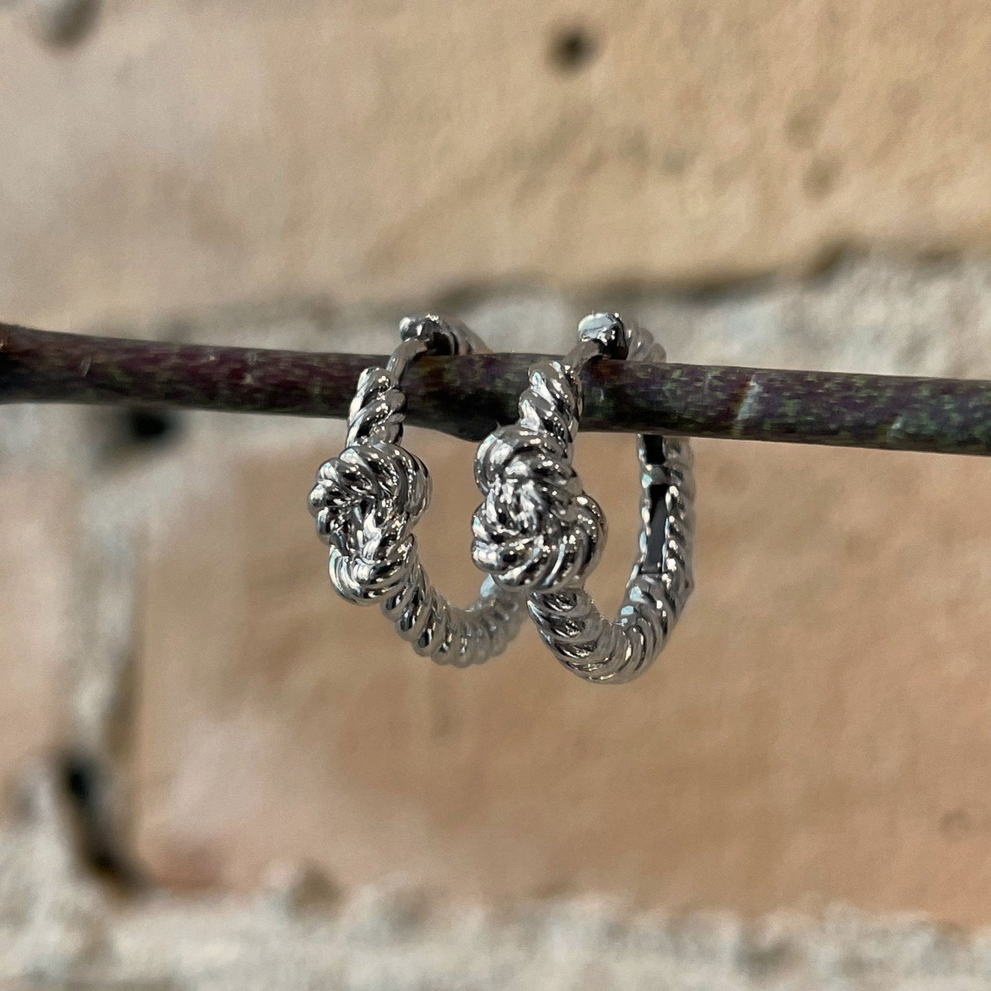 Photo of Nautical Knot Hoops in a decorative scene, designed by , available at Plumb Gold & Plumb Silver