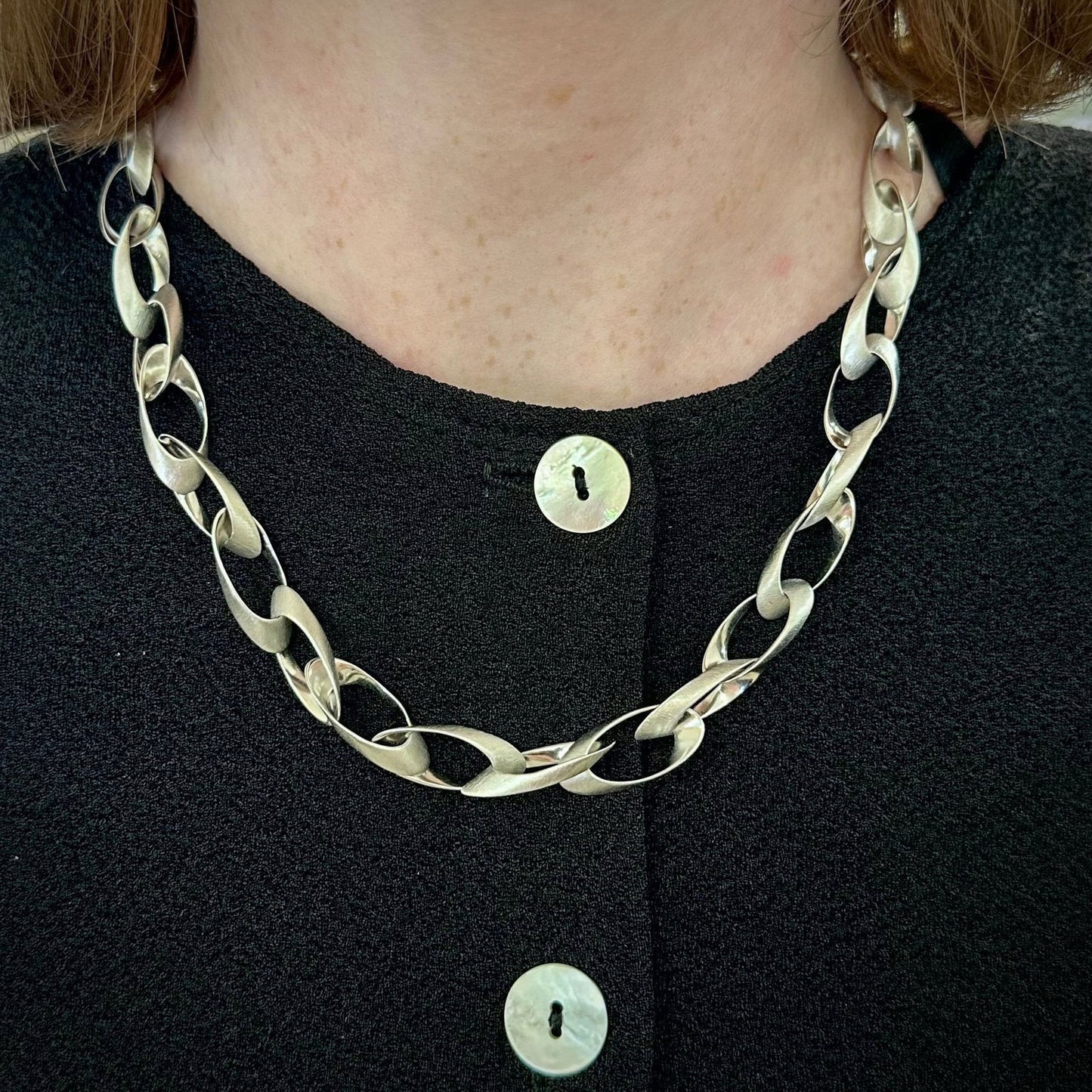 Photo of "Nova" Necklace in a decorative scene, designed by -, available at Plumb Gold & Plumb Silver