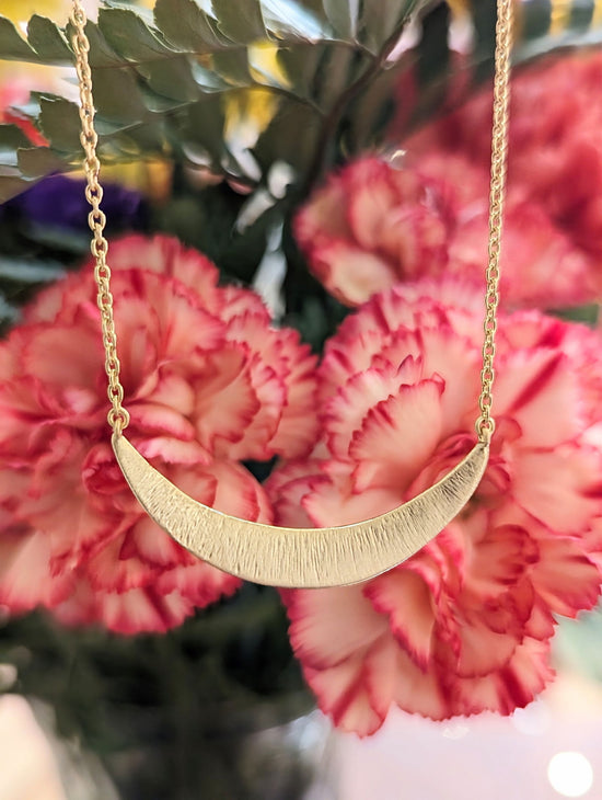 Photo of "Odyssey" Necklace in a decorative scene, designed by , available at Plumb Gold & Plumb Silver