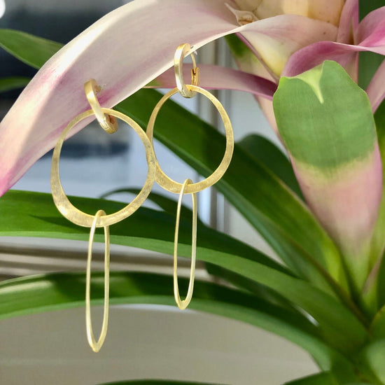Photo of "Olympia" Earrings in a decorative scene, designed by , available at Plumb Gold & Plumb Silver
