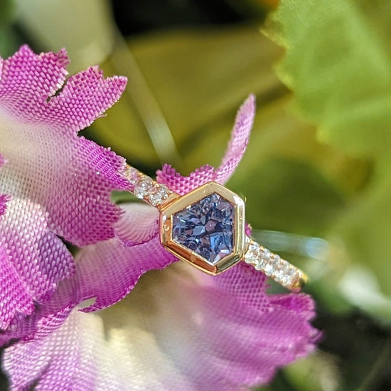 Photo of One of a Kind Blue Saphire Shield Stackable ring in a decorative scene, designed by , available at Plumb Gold & Plumb Silver