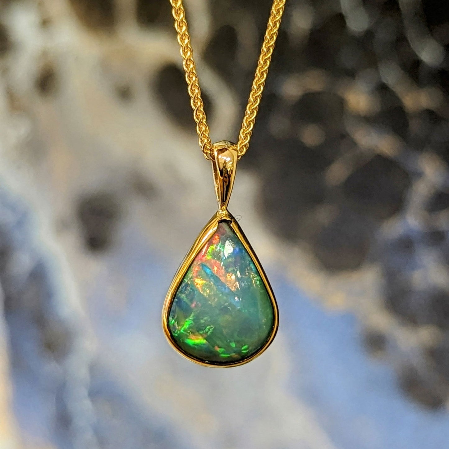 Photo of Opal Pendant in a decorative scene, designed by , available at Plumb Gold & Plumb Silver