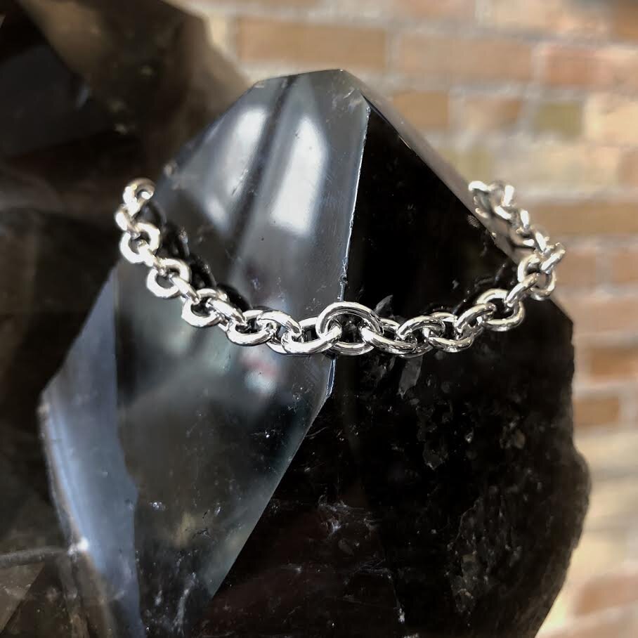 Photo of Oval Cable Bracelet in a decorative scene, designed by , available at Plumb Gold & Plumb Silver