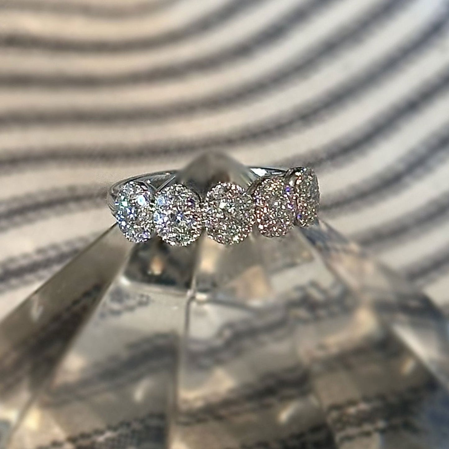 Photo of Oval Halo Diamond Ring in a decorative scene, designed by , available at Plumb Gold & Plumb Silver