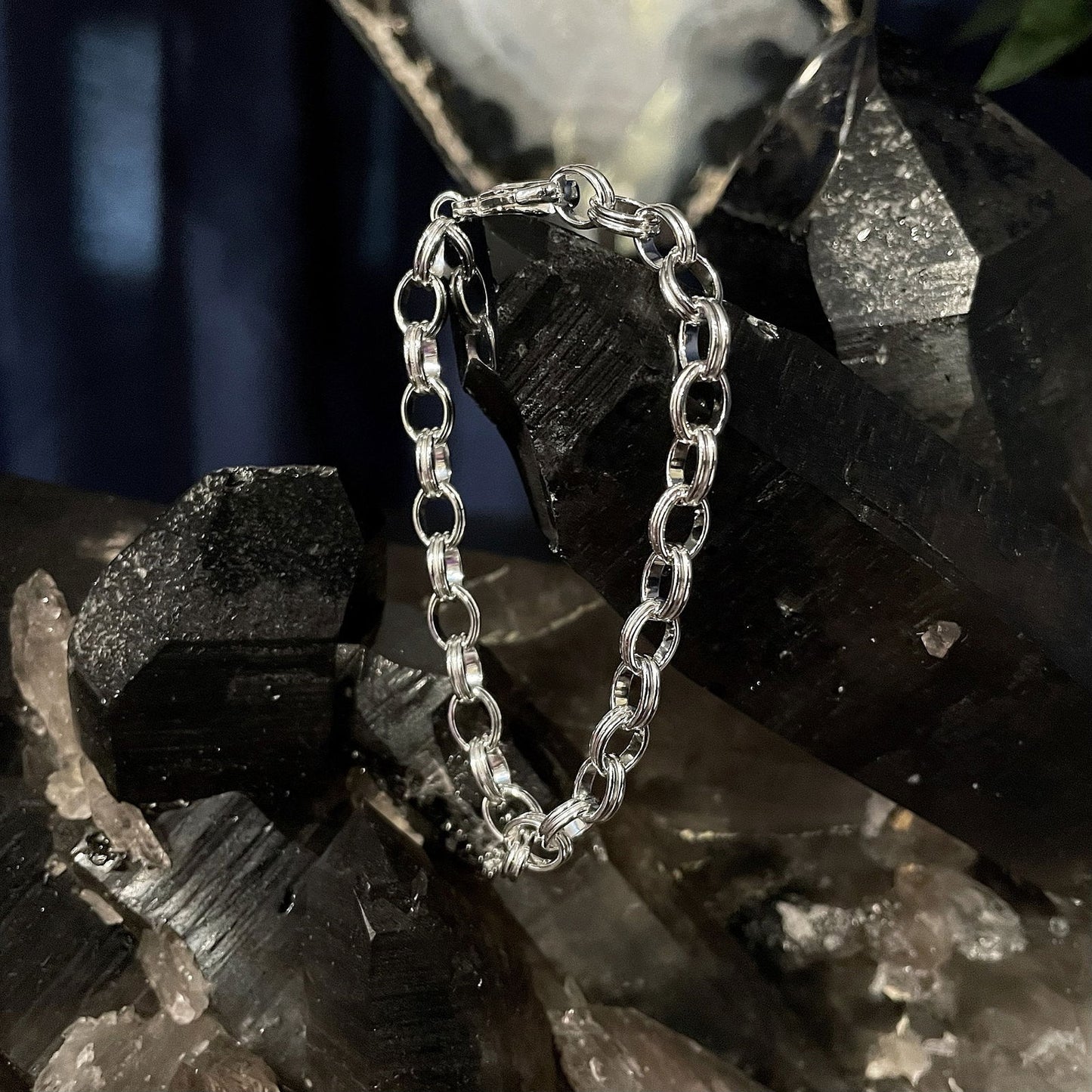 Photo of Oval Link Bracelet in a decorative scene, designed by , available at Plumb Gold & Plumb Silver