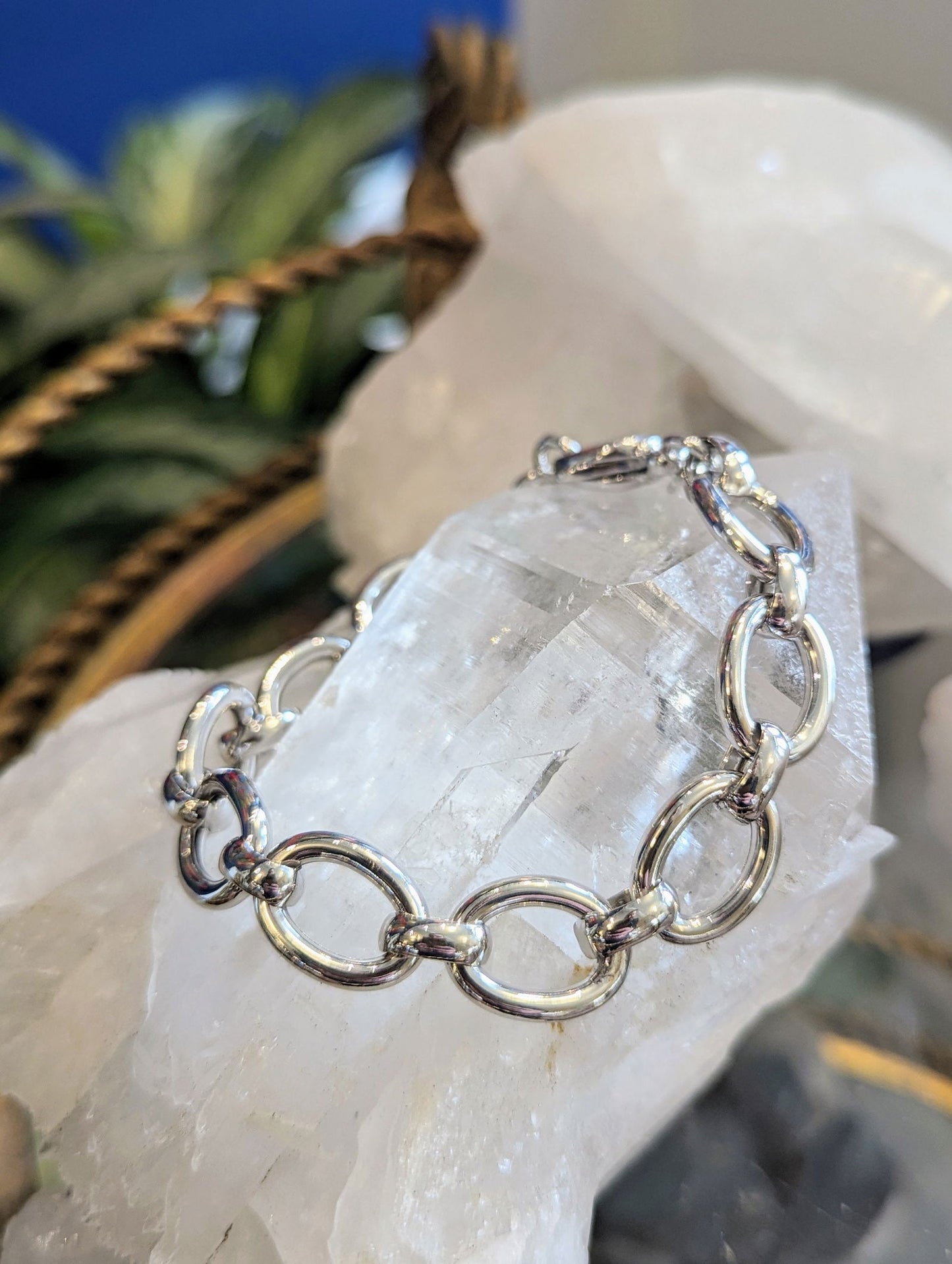 Photo of Oval Link Bracelet in a decorative scene, designed by , available at Plumb Gold & Plumb Silver