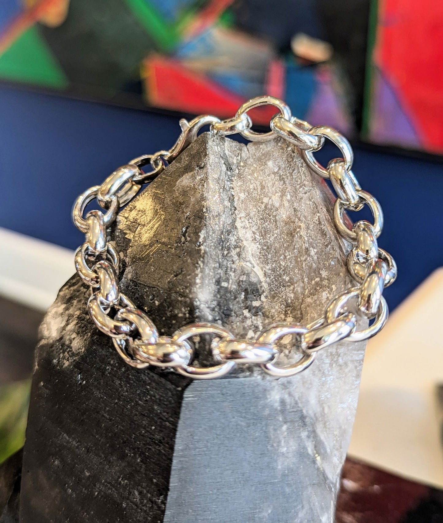 Photo of Oval Link Bracelet in a decorative scene, designed by , available at Plumb Gold & Plumb Silver