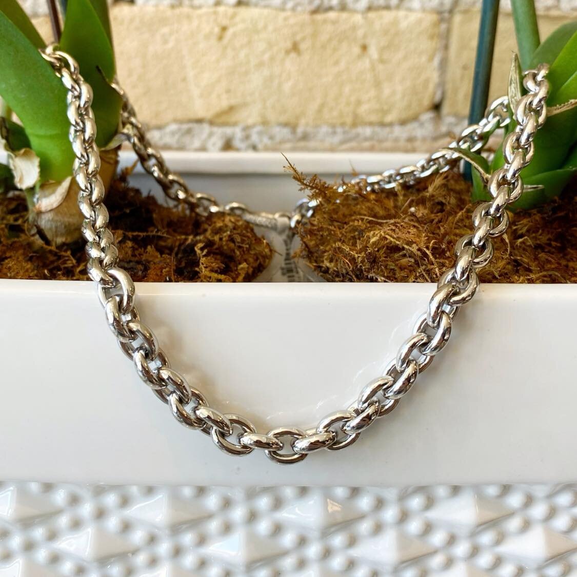 Photo of Oval Link Necklace in a decorative scene, designed by , available at Plumb Gold & Plumb Silver