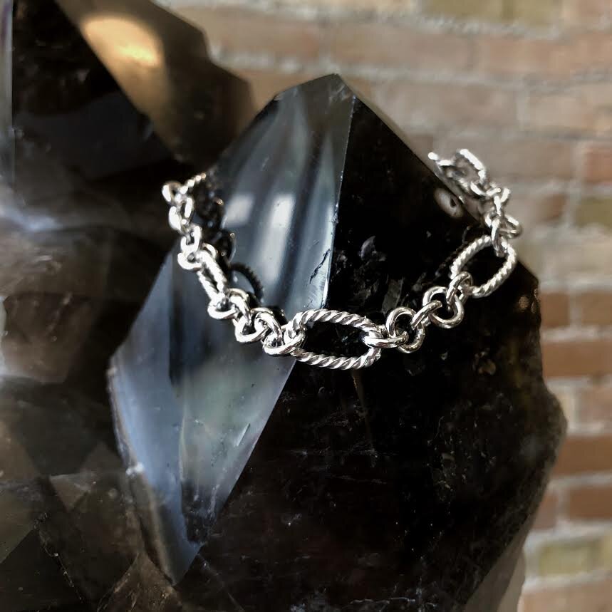 Photo of Oval Rope Bracelet in a decorative scene, designed by , available at Plumb Gold & Plumb Silver