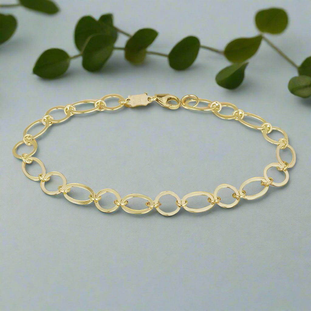 Photo of Ovals Link Bracelet in a decorative scene, designed by , available at Plumb Gold & Plumb Silver