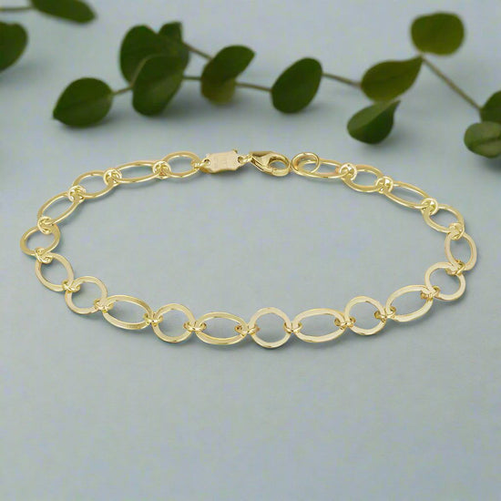 Photo of Ovals Link Bracelet in a decorative scene, designed by , available at Plumb Gold & Plumb Silver
