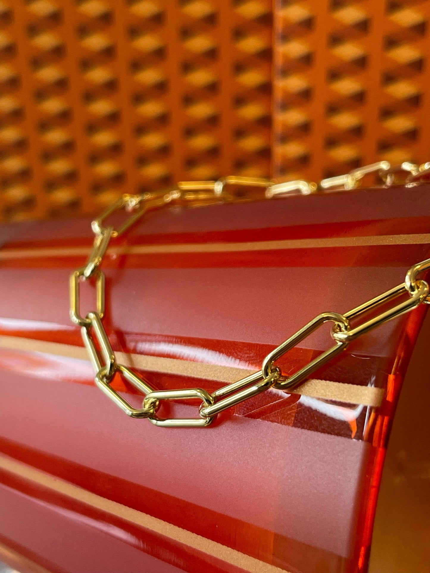 Photo of Paperclip Bracelet in a decorative scene, designed by , available at Plumb Gold & Plumb Silver