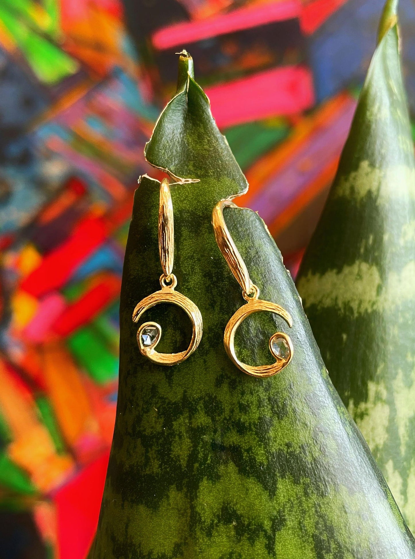 Photo of "Peacock" Earrings in a decorative scene, designed by , available at Plumb Gold & Plumb Silver