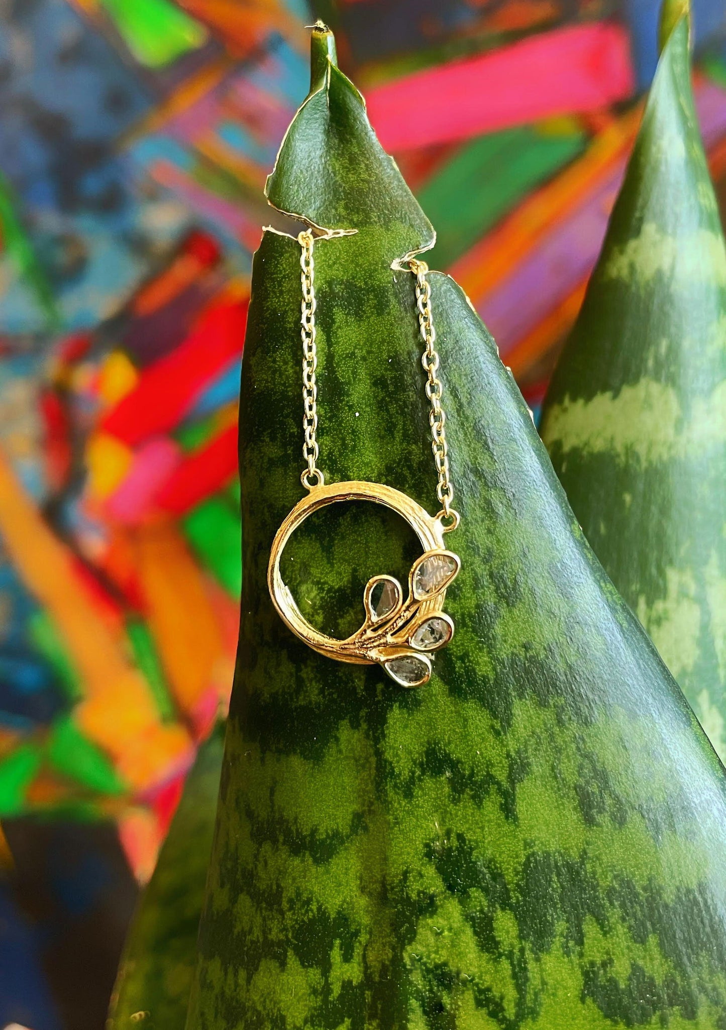 Photo of "Peacock" Necklace in a decorative scene, designed by , available at Plumb Gold & Plumb Silver