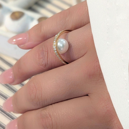 Photo of "Pearl Arch" Ring in a decorative scene, designed by , available at Plumb Gold & Plumb Silver