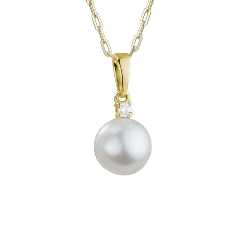 Photo of Pearl Solitaire Necklace in a decorative scene, designed by , available at Plumb Gold & Plumb Silver