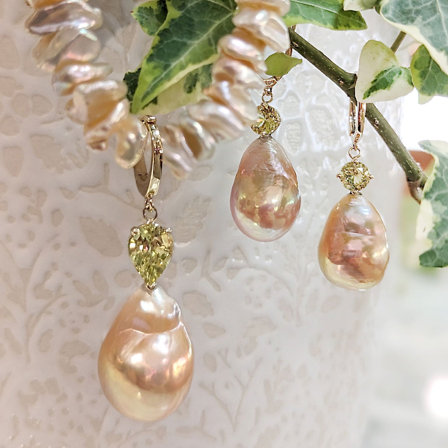 Photo of Pearl and Chrysoberyl Earrings in a decorative scene, designed by , available at Plumb Gold & Plumb Silver