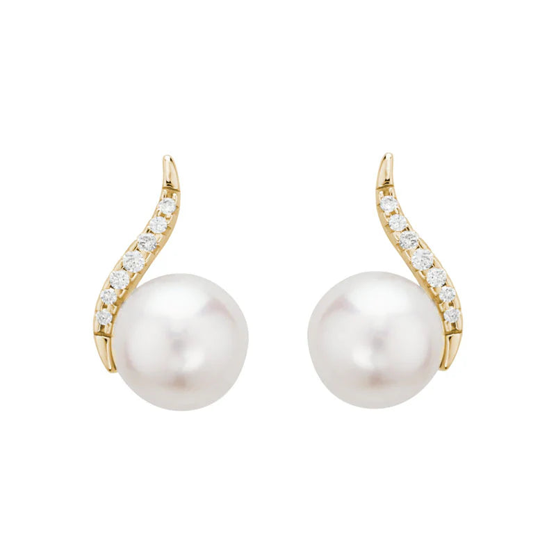 Photo of Pearl and Diamond Curve Stud in a decorative scene, designed by , available at Plumb Gold & Plumb Silver
