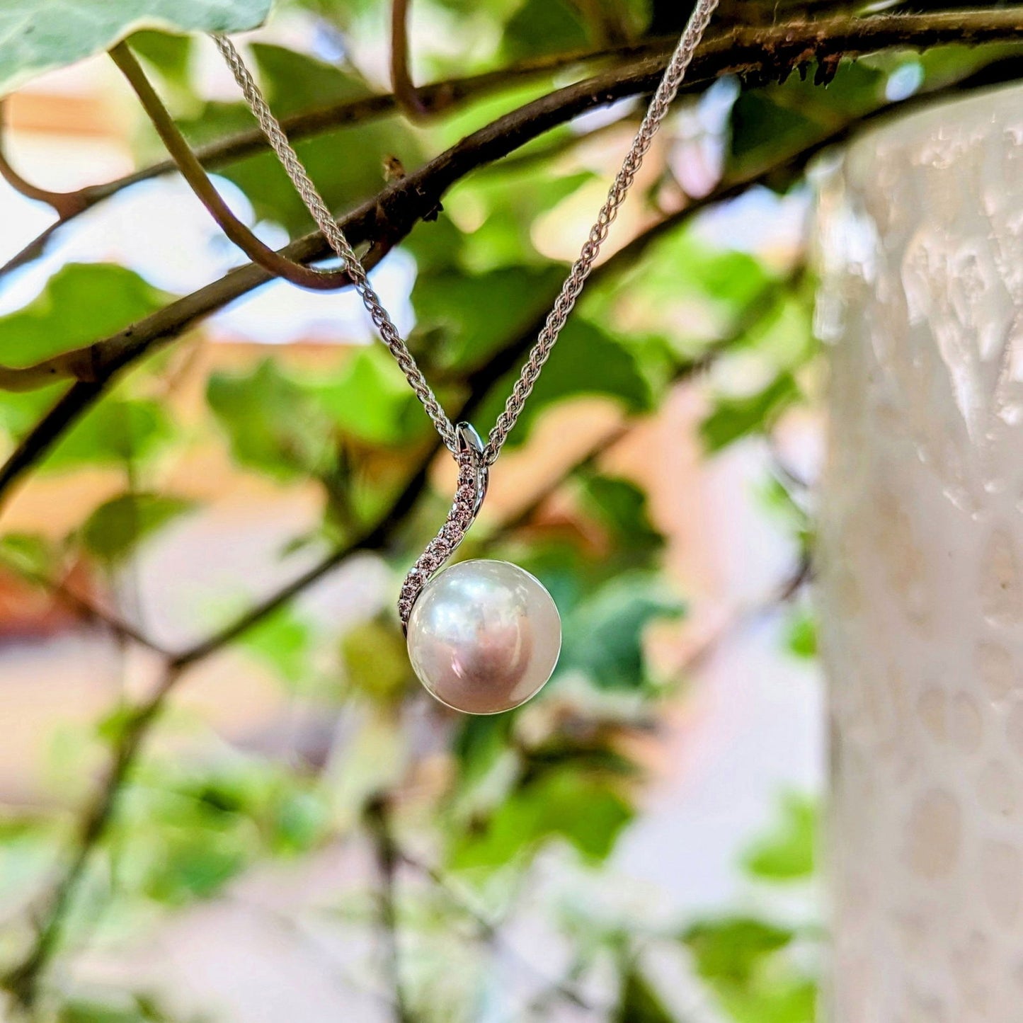 Photo of Pearl and Diamond Necklace in a decorative scene, designed by , available at Plumb Gold & Plumb Silver