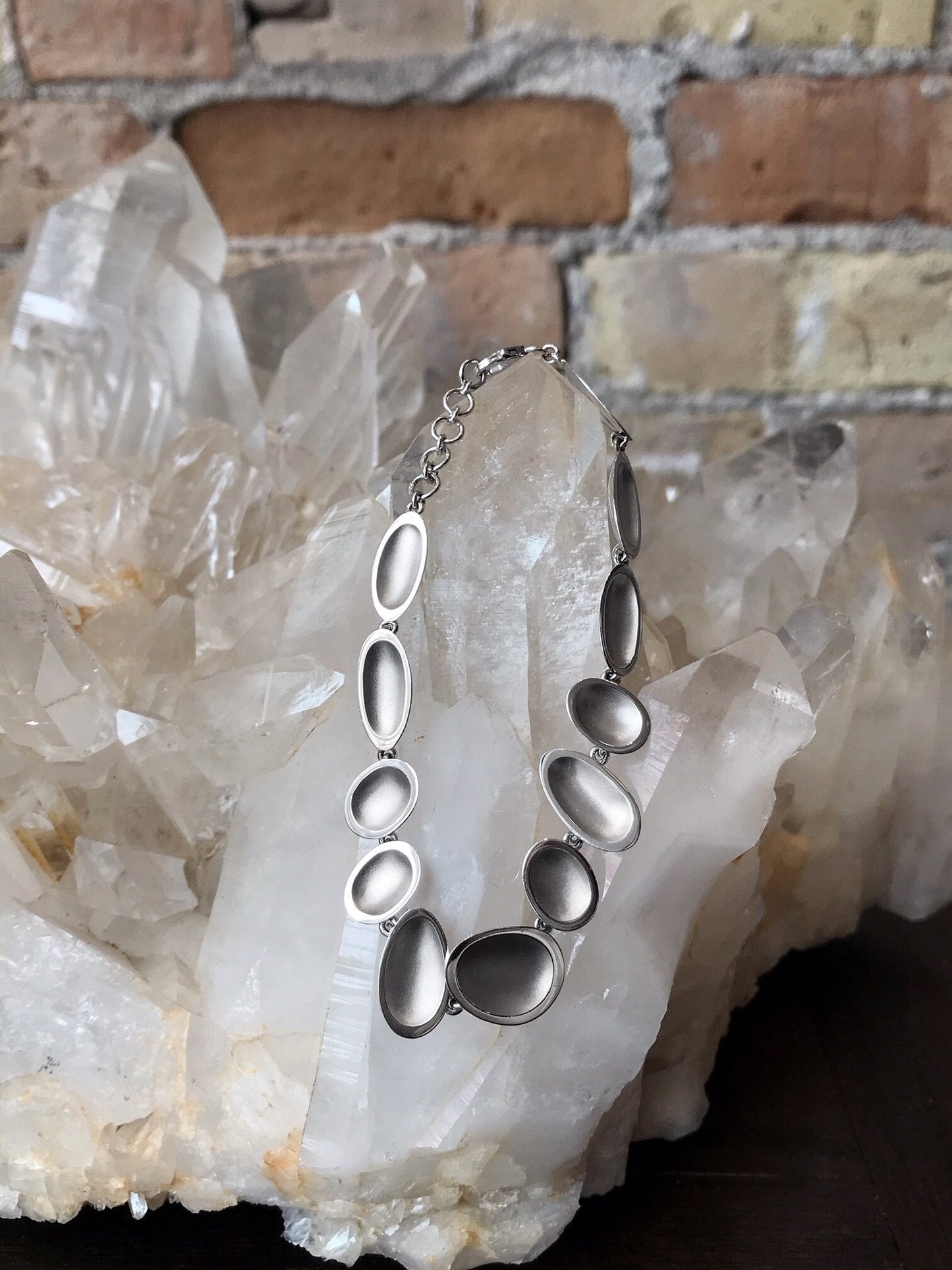 Photo of Pebble Bracelet in a decorative scene, designed by , available at Plumb Gold & Plumb Silver
