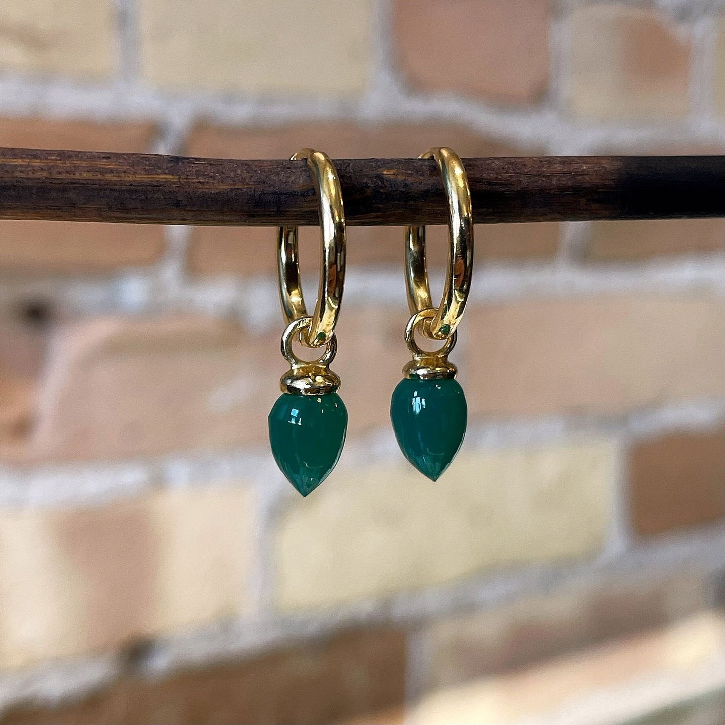 Photo of “Pendulum” Green Onyx Dangles in a decorative scene, designed by , available at Plumb Gold & Plumb Silver