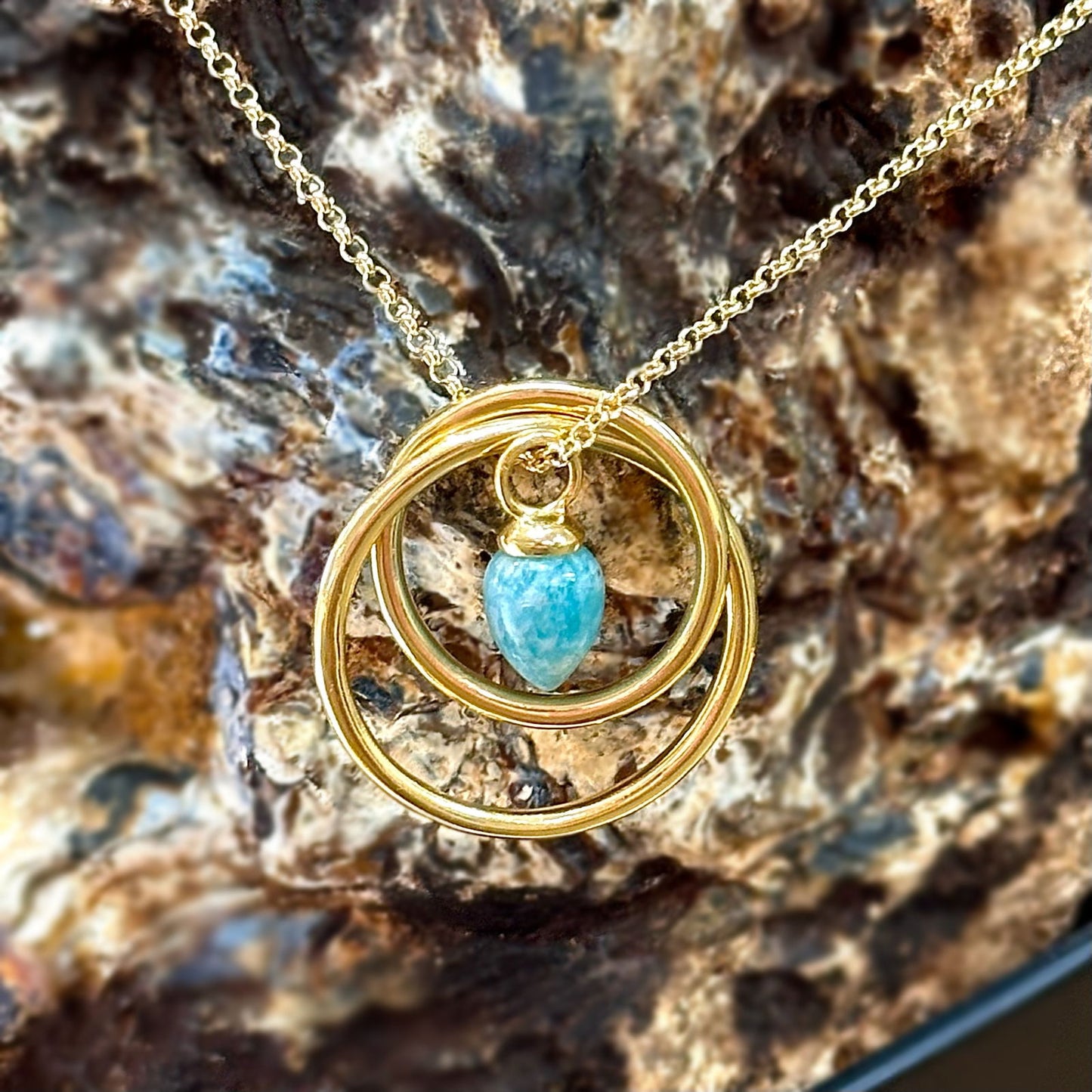 Photo of Pendulum Necklace in a decorative scene, designed by -, available at Plumb Gold & Plumb Silver