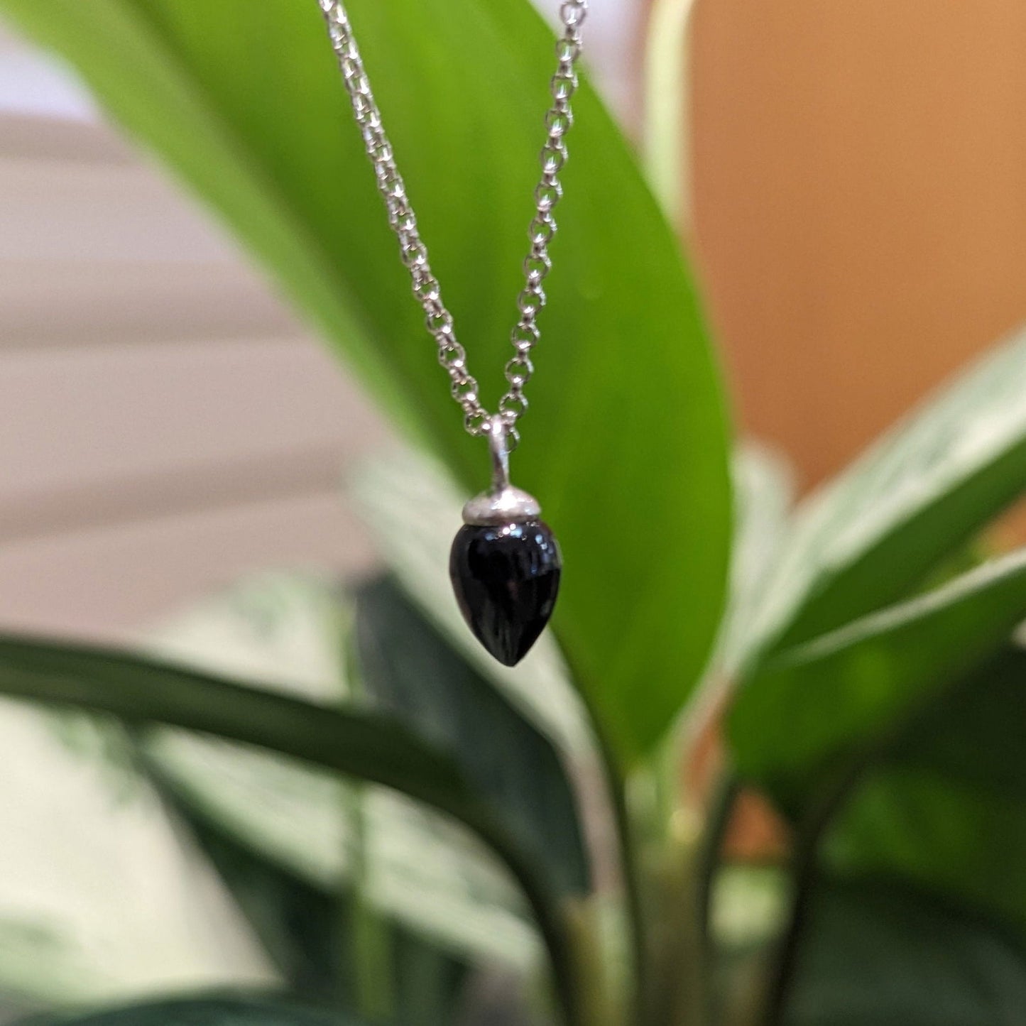 Photo of "Pendulum" pendant in a decorative scene, designed by , available at Plumb Gold & Plumb Silver